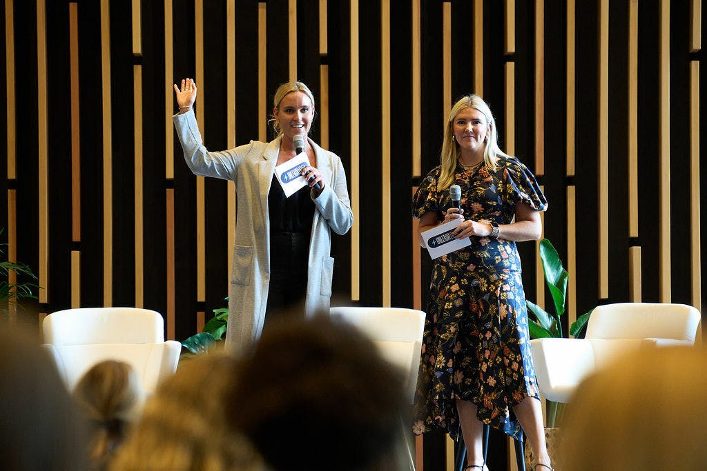 women on stage at a conference