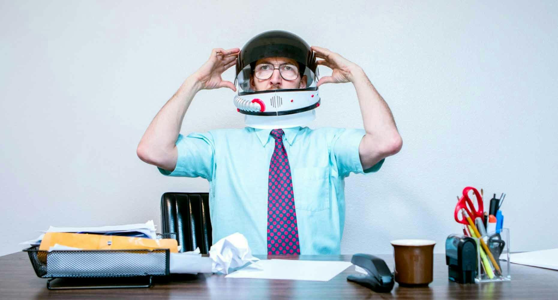 Astronaut sales person sitting at desk