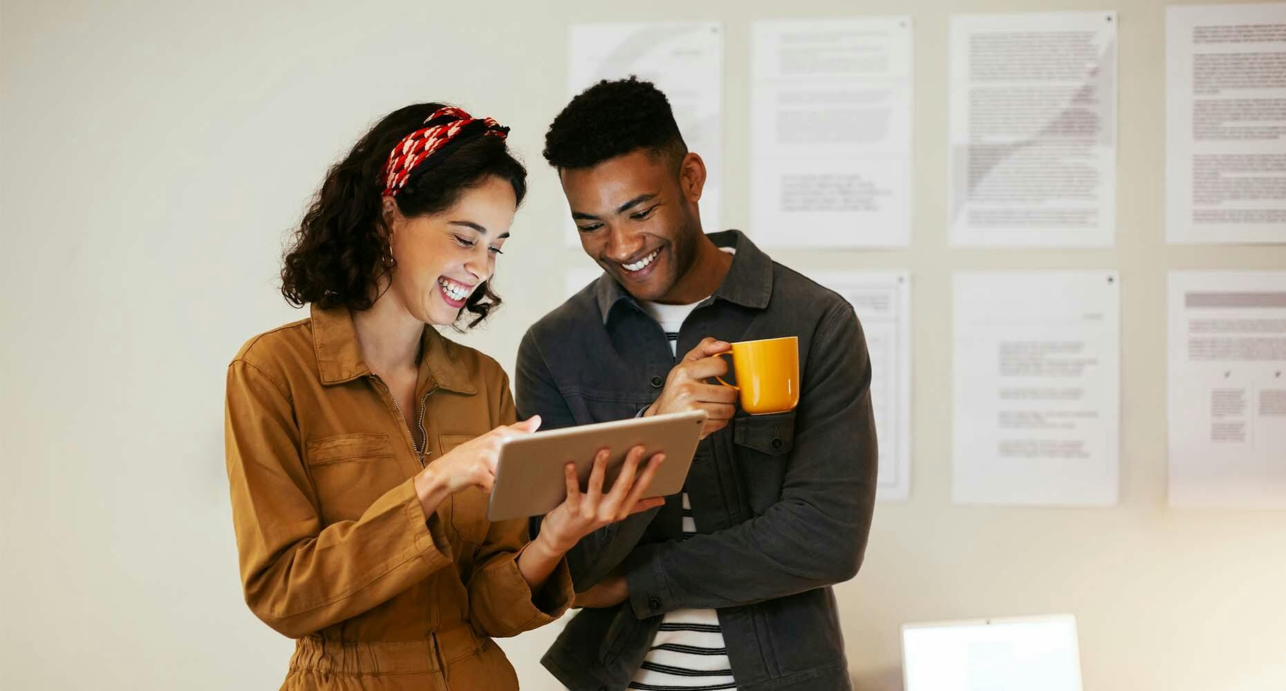 Man and woman collaborating on a tablet